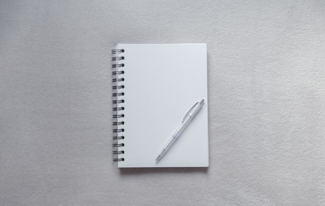 Open notebook with a handwritten checklist and pen